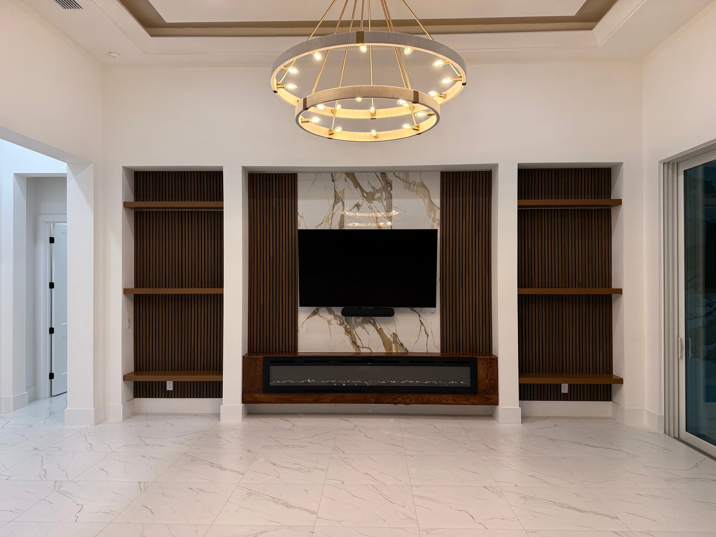 Media Wall with Built-In Shelving and a Tray Ceiling Detail in Sarasota, FL